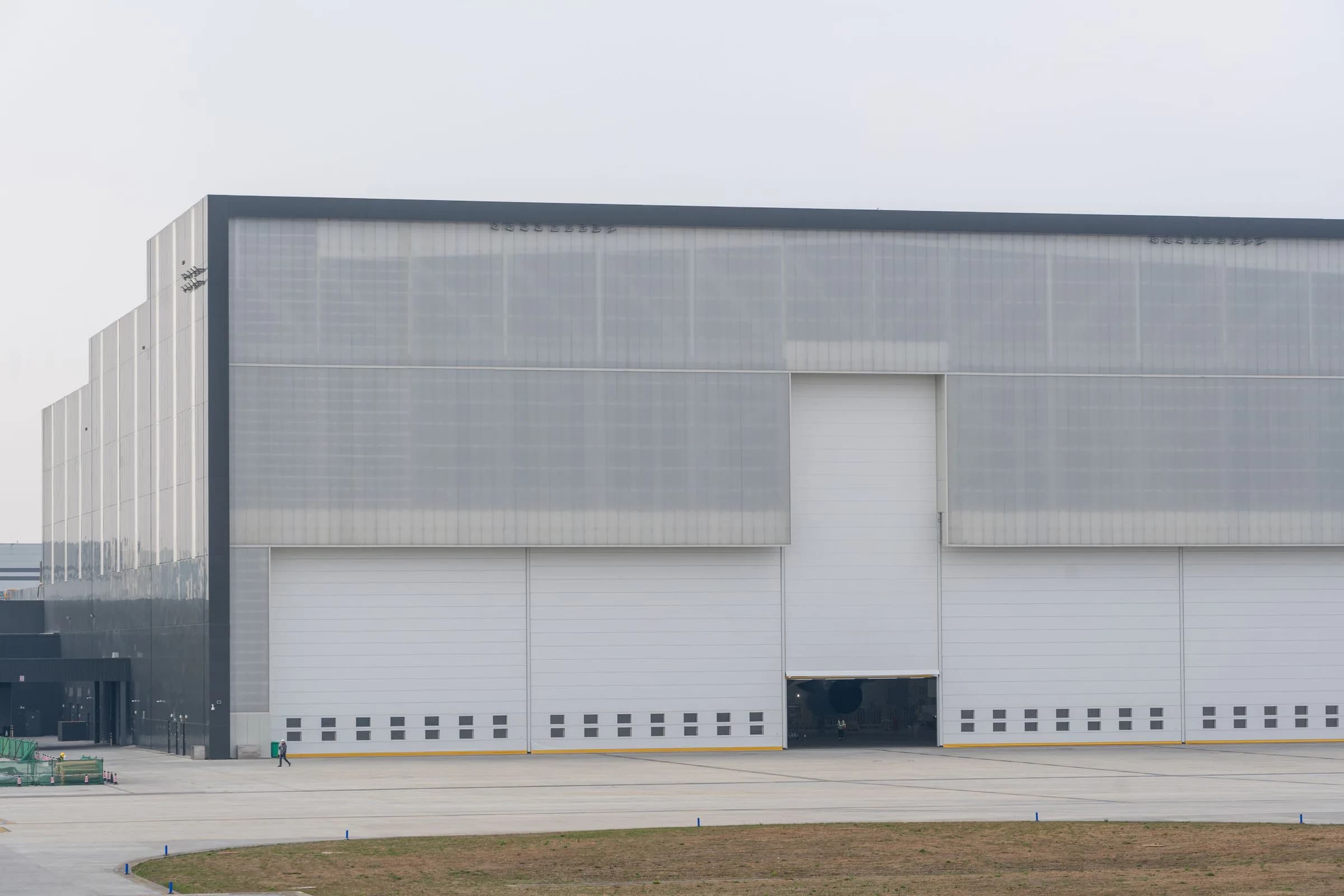 Large contemporary industrial warehouse with a clear-span facade and loading access